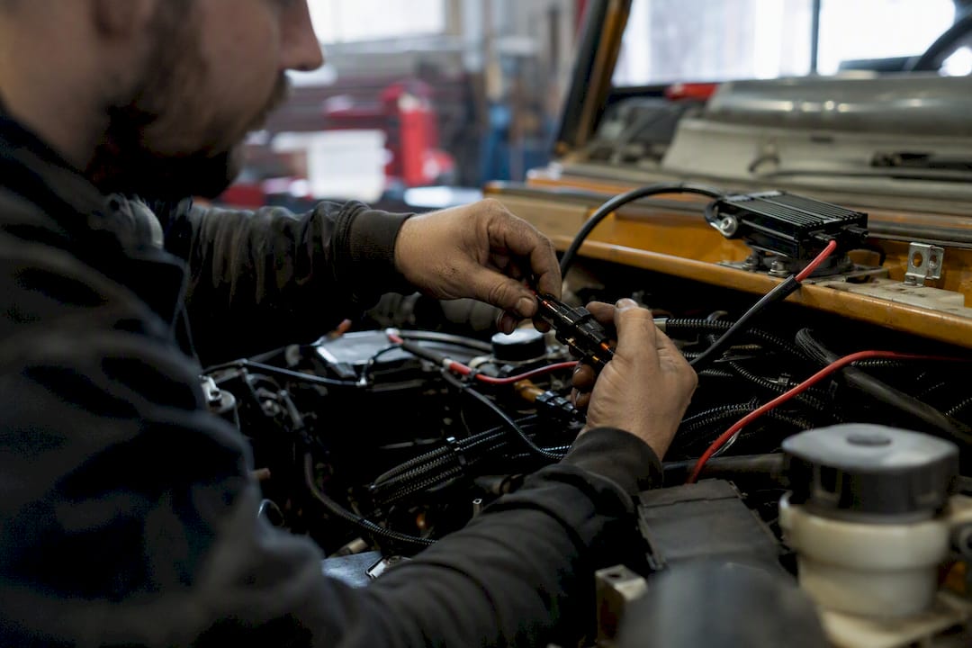 Technician wiring LED strobe in engine bay