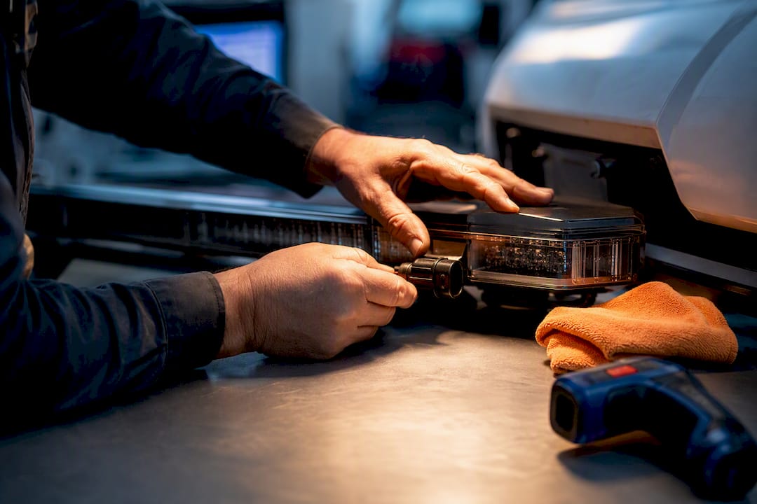 Technician inspecting vehicle light warranty evidence