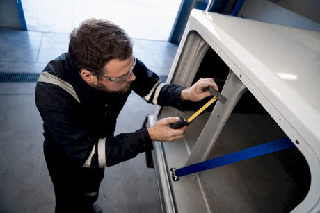 Technician measuring anonymous fleet cargo clearance