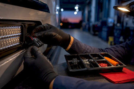 Technician swapping a fleet lighting harness